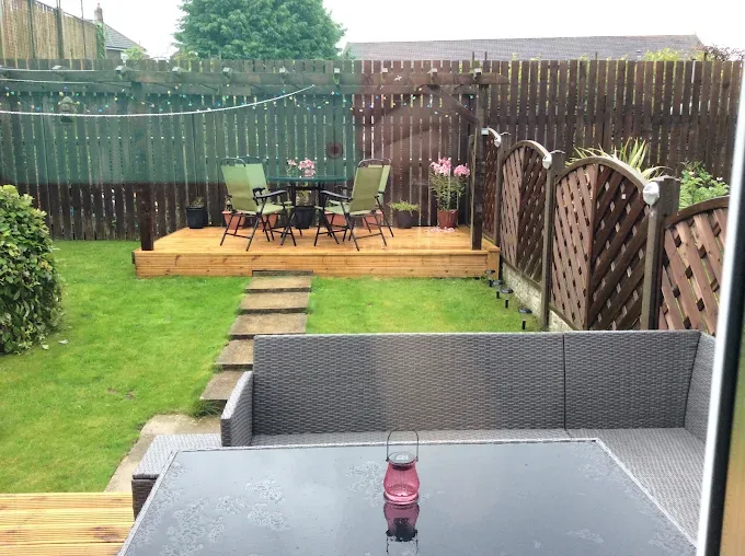 Garden decking area with seating and pergola