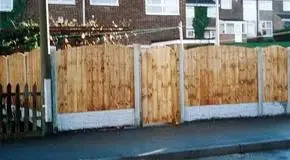 Close-board timber fence installation on a residential street