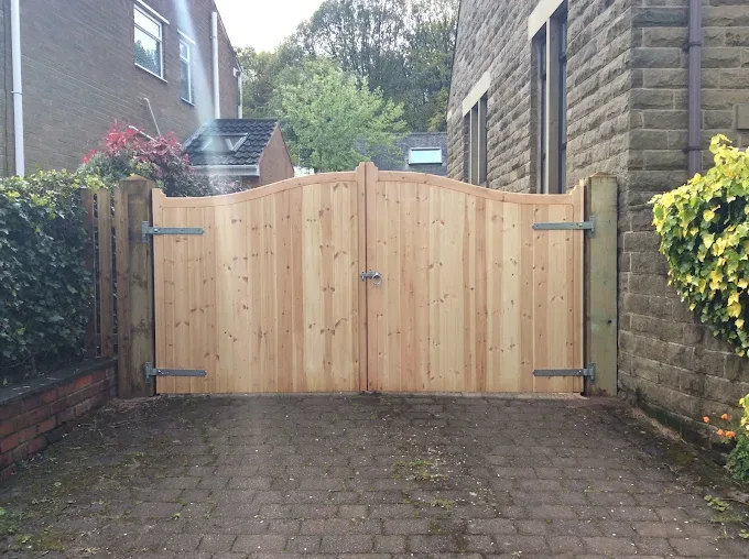 Bespoke curved-top driveway gates in natural timber